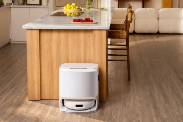 A sleek robot vacuum sits under a kitchen island, showcasing the future of robot vacuum technology in modern homes.