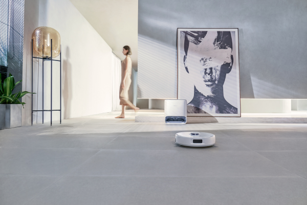 A modern living space featuring a robotic vacuum, ideal for maintaining the best vacuum for concrete floors.