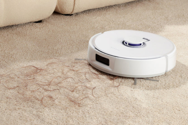 A robot vacuum efficiently cleans carpet, picking up human hair, showcasing the best robot vacuum for human hair.
