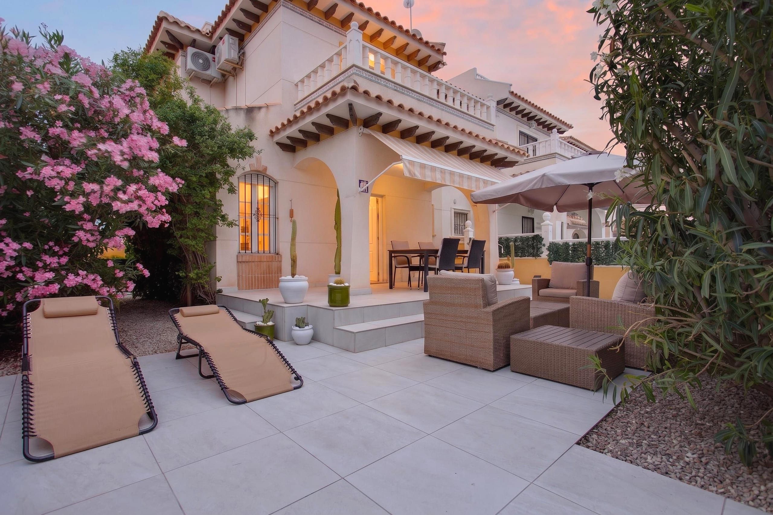 Townhouse with private solarium in Lomas de Cabo Roig, Orihuela Costa — exterior view at dusk