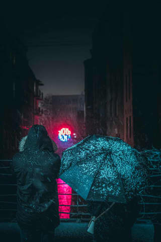 People watching famous neon sign