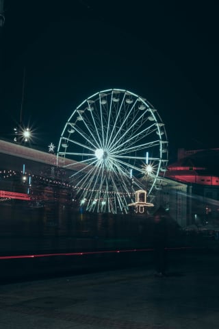Long exposure of tram and Ferris wheel at the fair