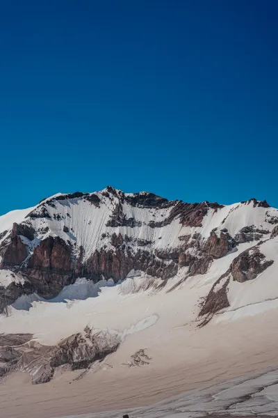 Rocky Snow Wall Under a Deep Blue Sky