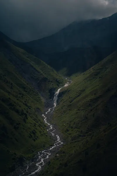 Winding Stream in a Dark Green Valley
