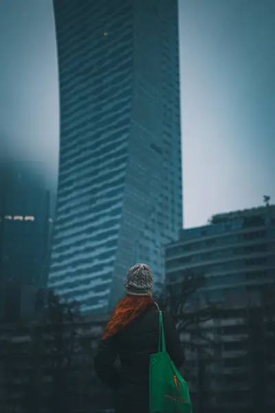 Woman in front of skyscraper