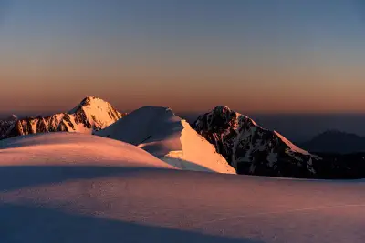 Golden Alpenglow on the Snowy Ridge