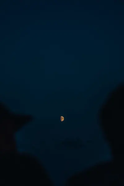 Two people and the Moon