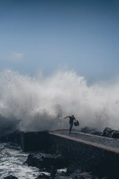 Man chased by wave at Calhau da Lapa