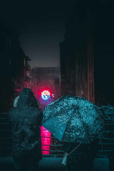 People watching famous neon sign