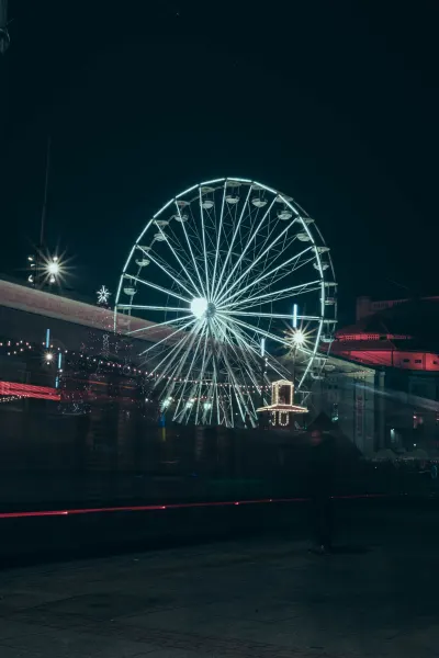 Long exposure of tram and Ferris wheel at the fair