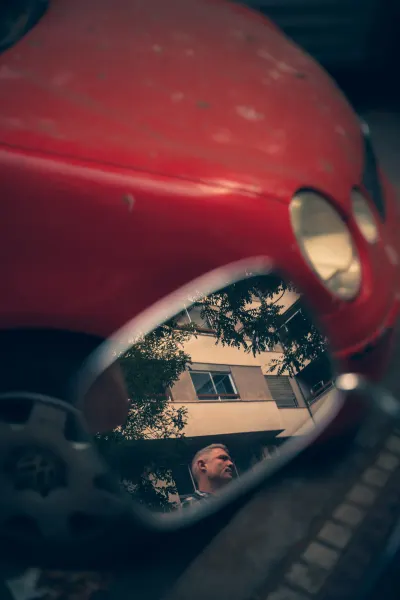 Reflection of a man in scooter mirror
