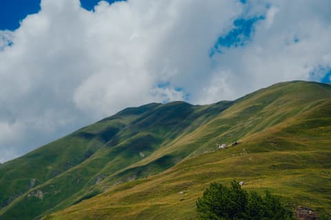 Velvet Green Slopes and Dramatic Sky