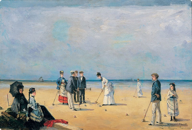 A group of elegantly dressed men and women playing croquet on a beach, with two women seated under an umbrella in the foreground and a ship visible in the distance.