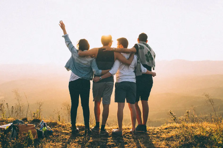 group of friends having fun at sunset