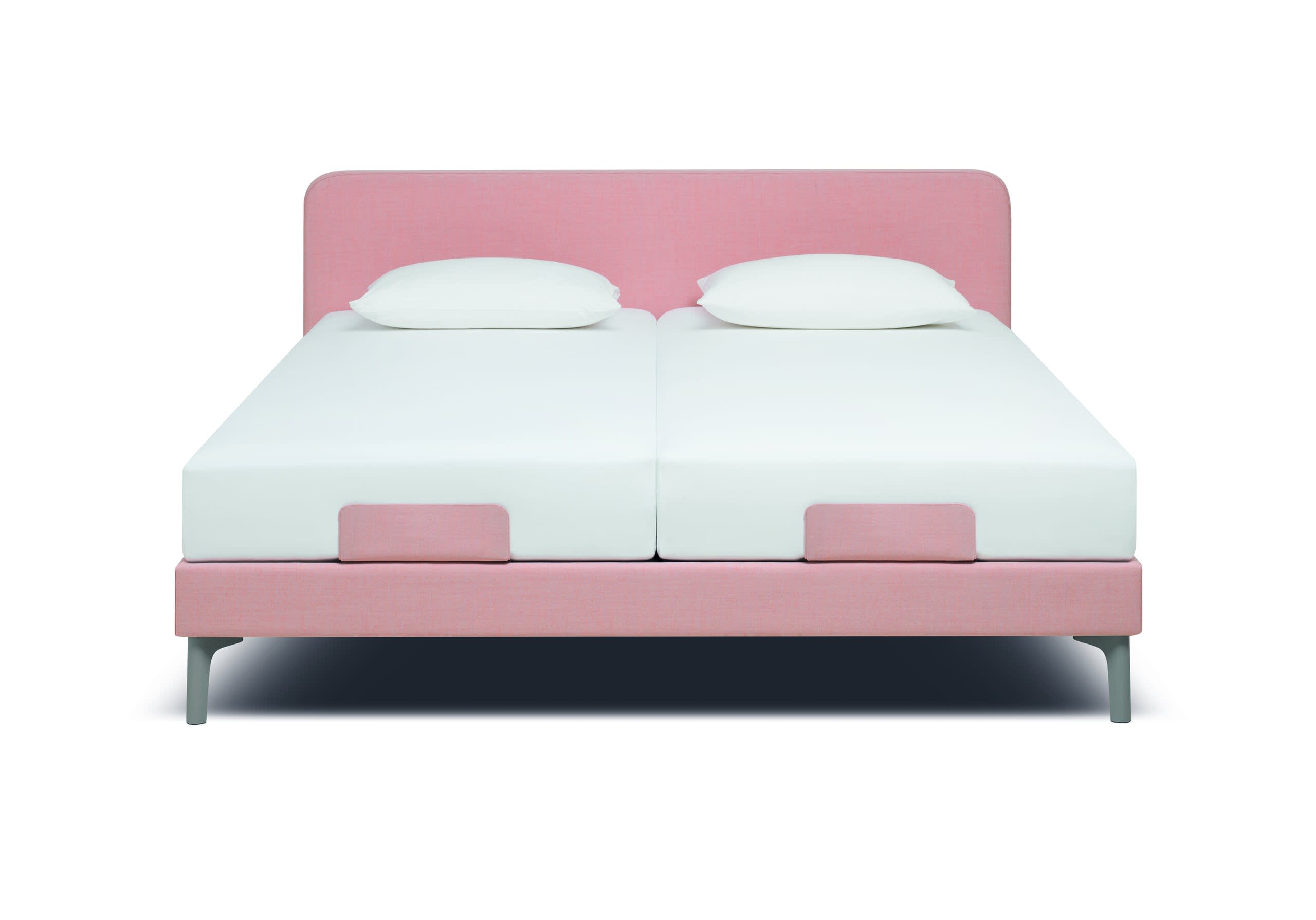 Das Riposa Boxspringbett Slow ist in rosa mit zwei Doppelmatratzen und zwei weißen Kissen auf weißem Hintergrund abgebildet.