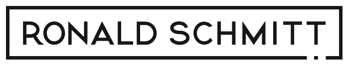 Inscription « RONALD SCHMITT » en lettres majuscules noires, entourée d'un cadre rectangulaire noir sur fond blanc.