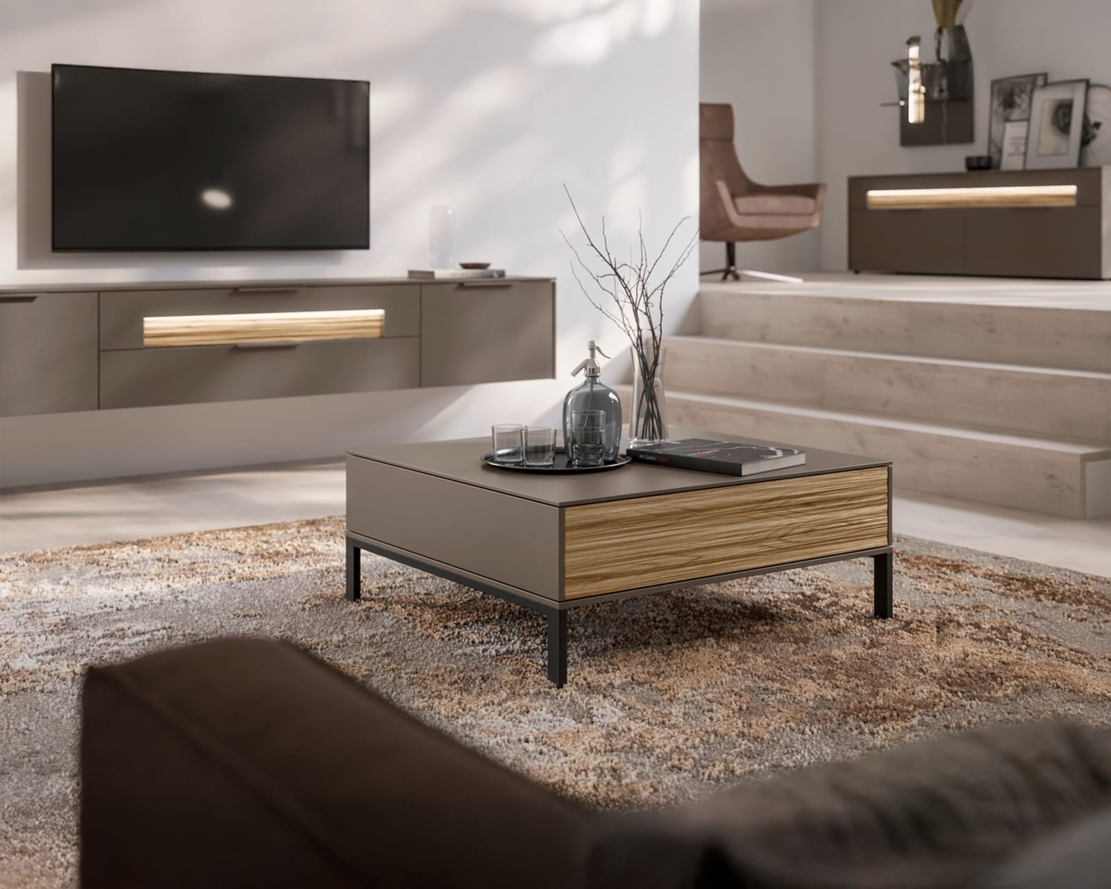 Modernes Wohnzimmer in neutralen Farbtönen, mit dem eleganten Couchtisch SALE 25 Wohnkombination Linee, TV-Set und gemütlicher Sitzecke.