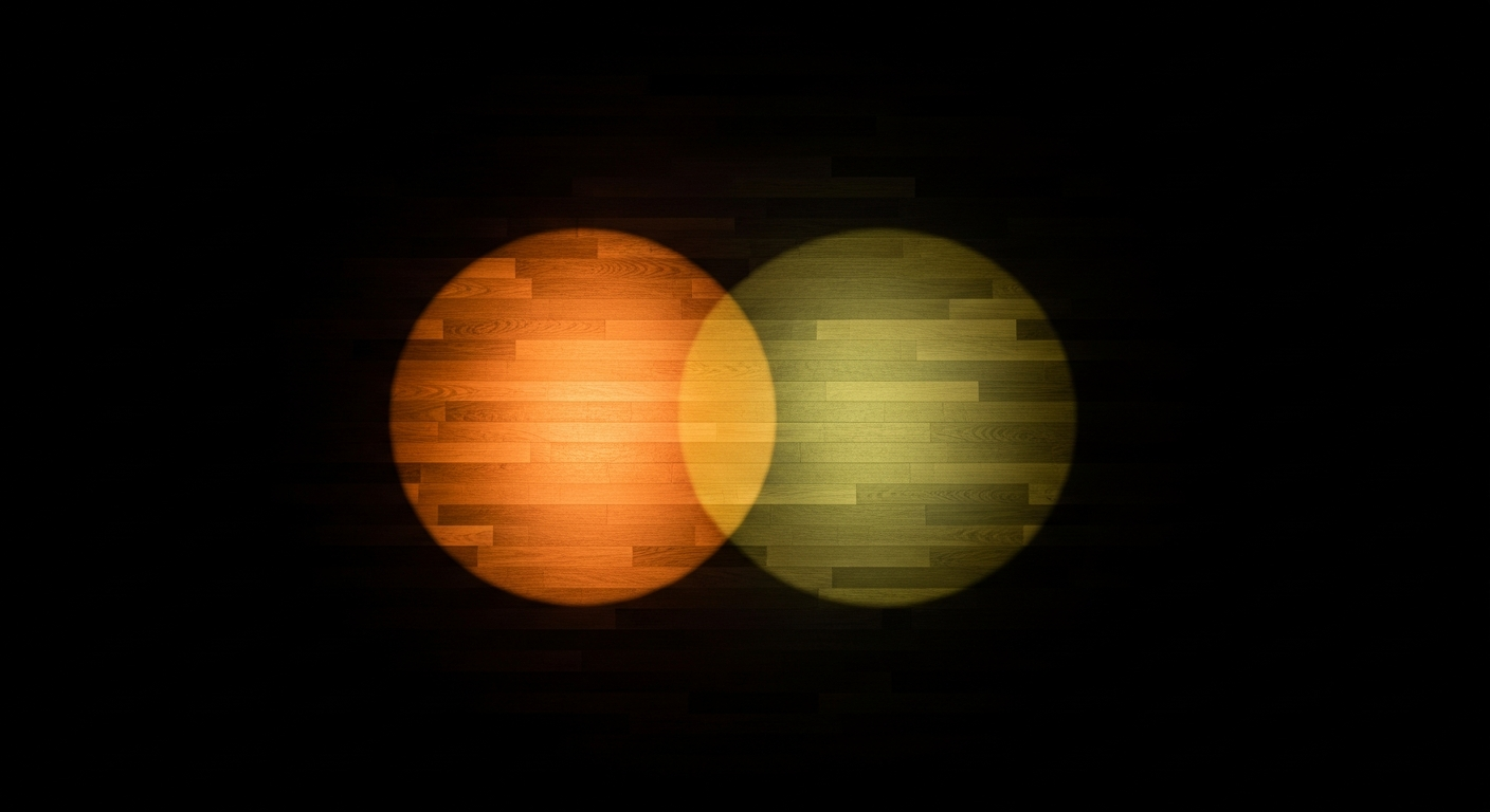 Two overlapping spotlights on a dark stage floor creating a distorted third color where they meet