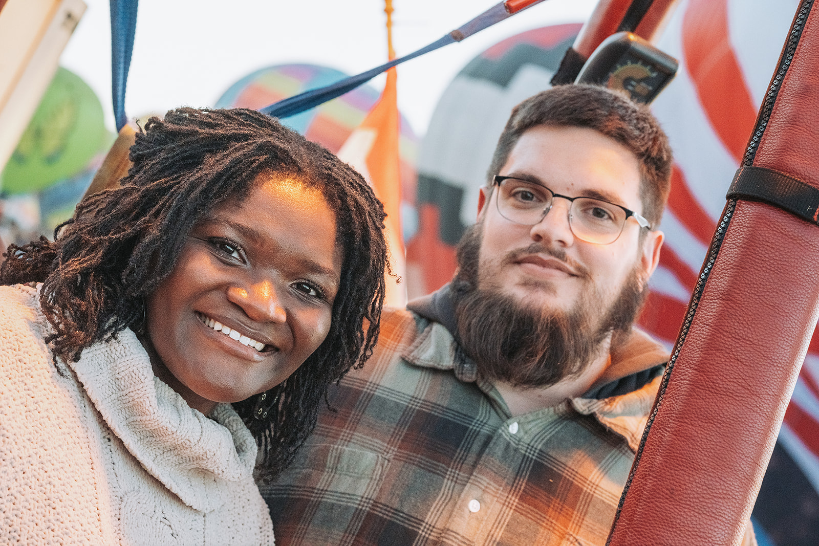 Couple portrait against colorful mural in warm golden hour light