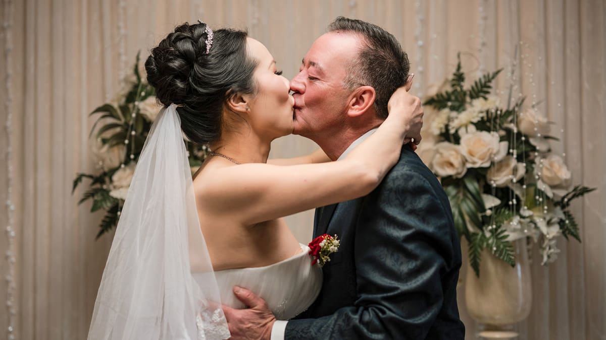 Christian and Yoyo kiss at the altar of the ABQ Wedding Chapel, Albuquerque