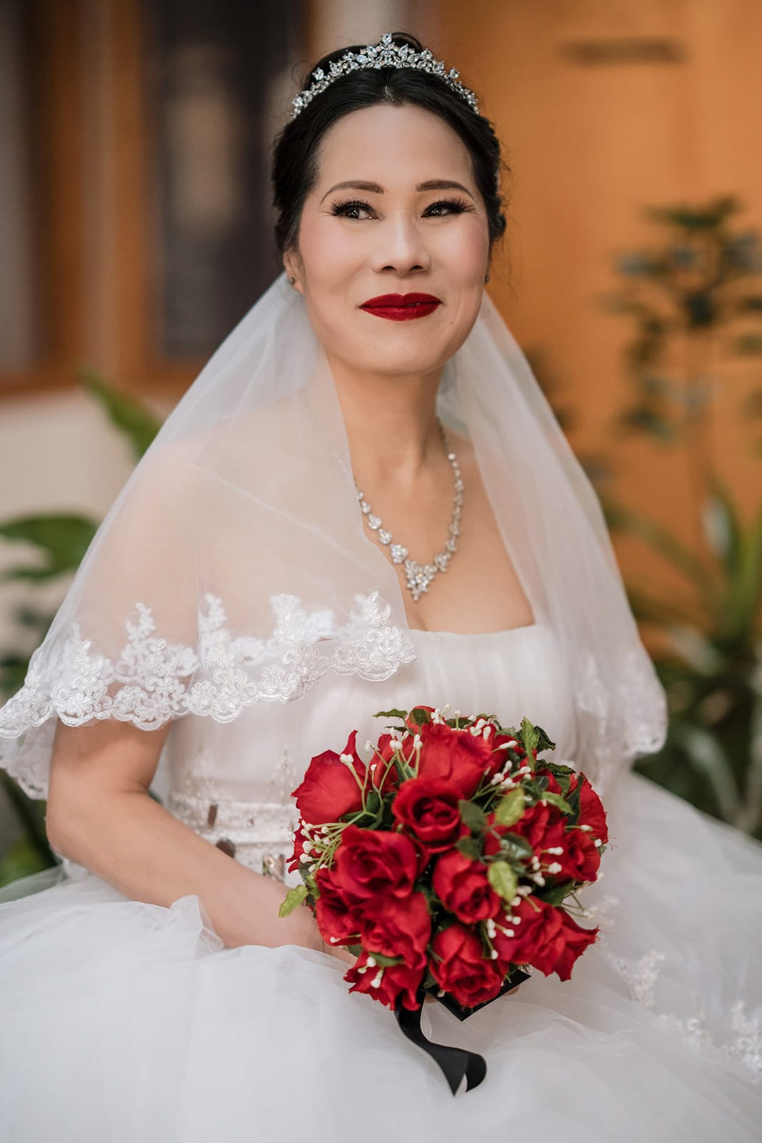 Yoyo holding a bouquet of red roses