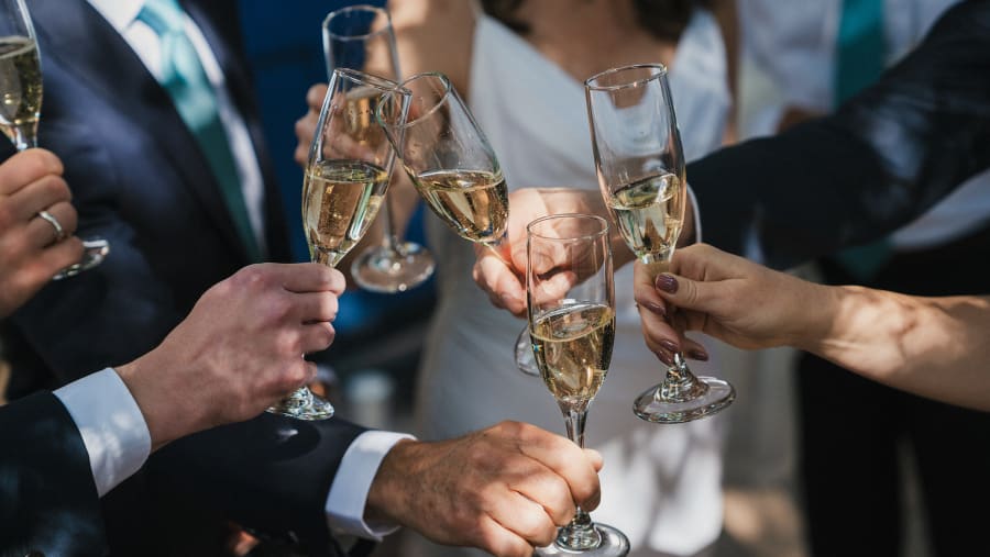 Champagne glasses raised in a toast