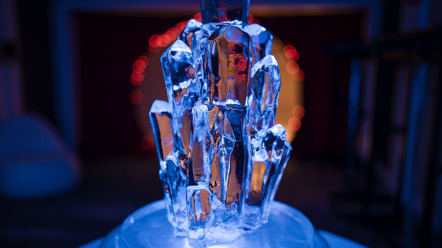 Ice sculpture lit electric blue at a gala