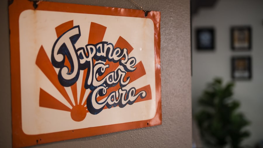Hand-painted Japanese Car Care sign inside the shop