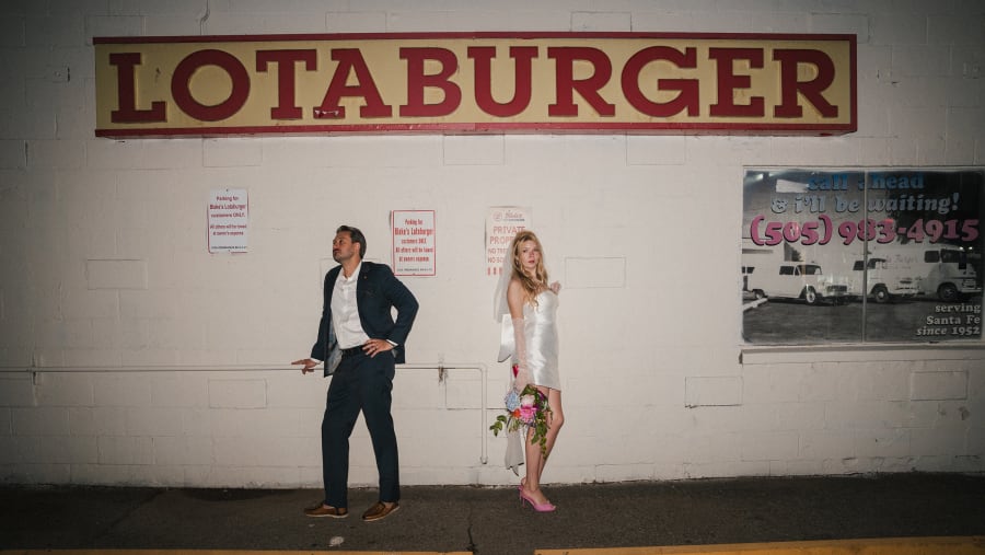 Bride and groom against the Lotaburger wall