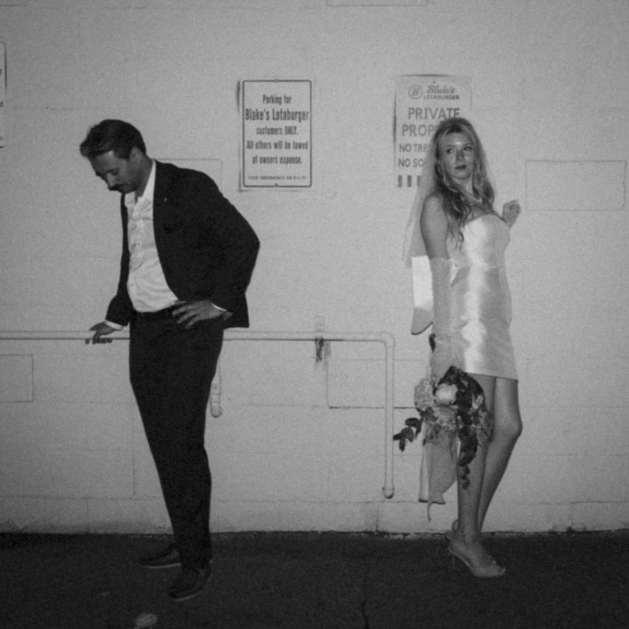 Couple against the Lotaburger wall at night, black and white