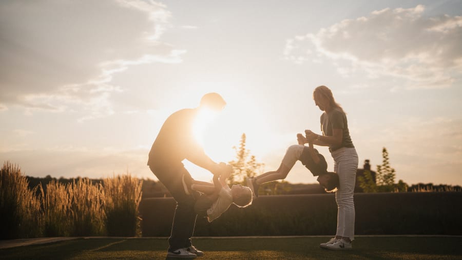 Two figures in silhouette against the setting sun