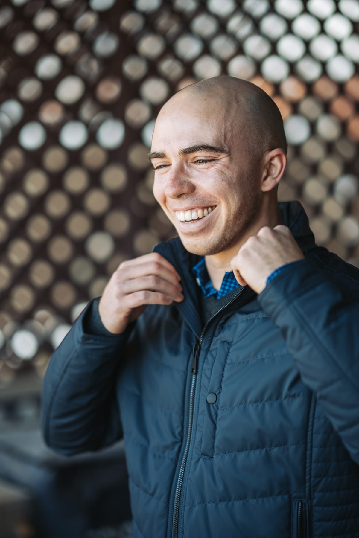 Casual outdoor professional headshot against industrial backdrop — Casey Addason Photography