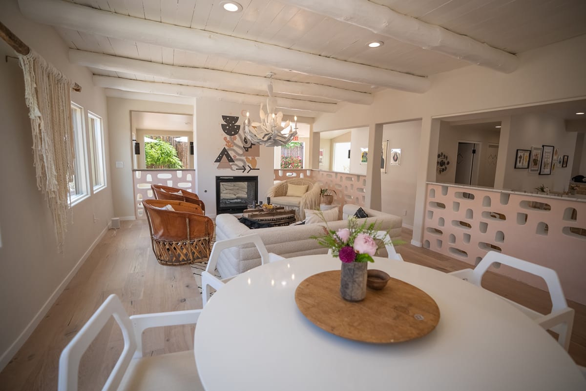 Open-concept dining and living area with exposed beams — Casey Addason Photography