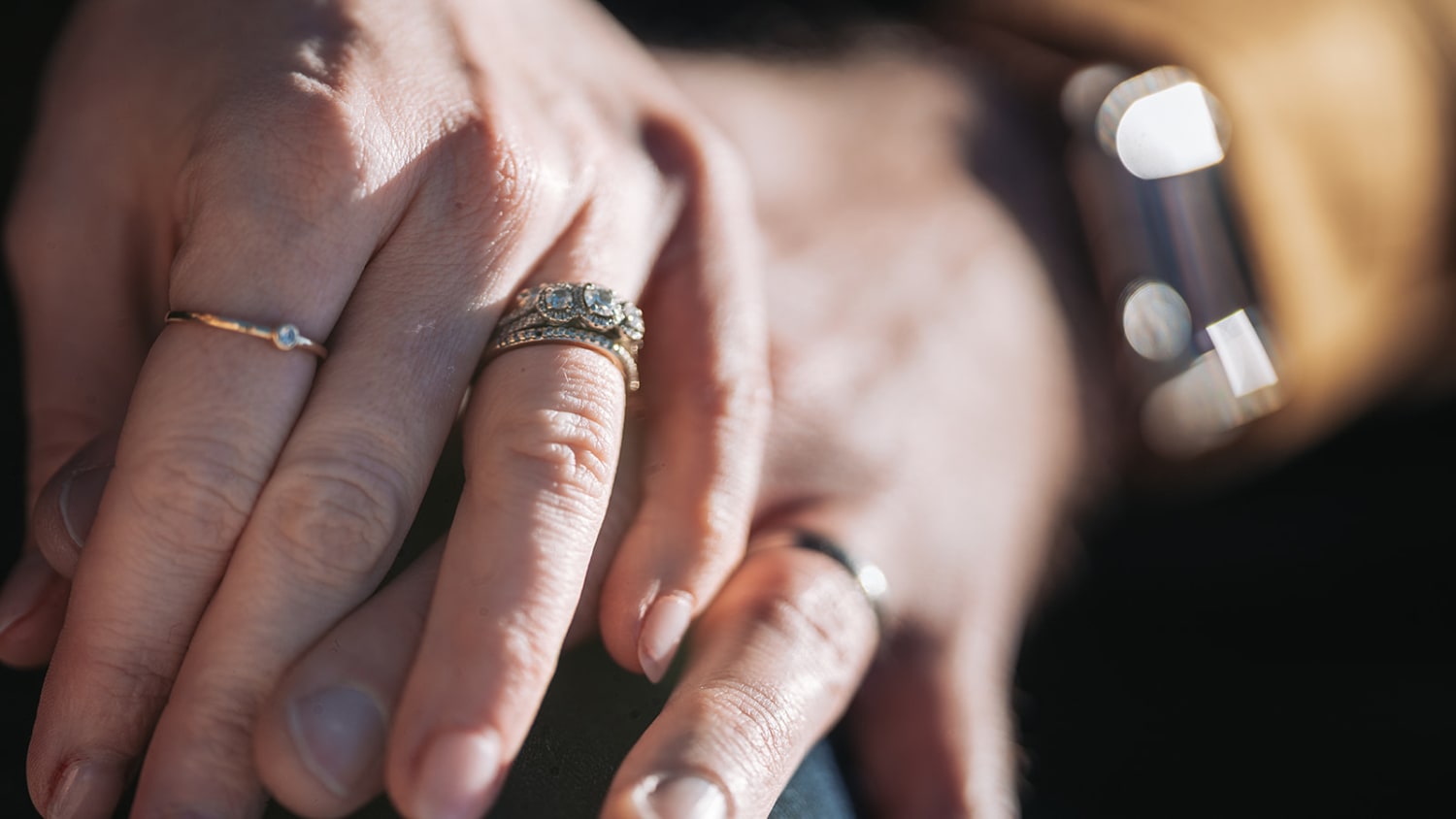Bishops Lodge wedding photographer Santa Fe - This intimate close-up captures an engaged couple's hands displaying their wedding bands in natural,