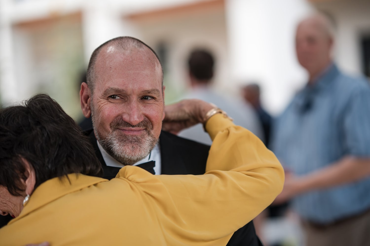 celebration captures a candid moment between two guests in what appears to be a Southwestern venu... — Casey Addason Photography