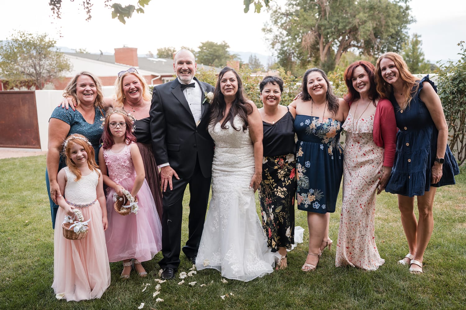 family portrait was taken in a garden setting featuring manicured grass, mature trees, and rustic... — Casey Addason Photography