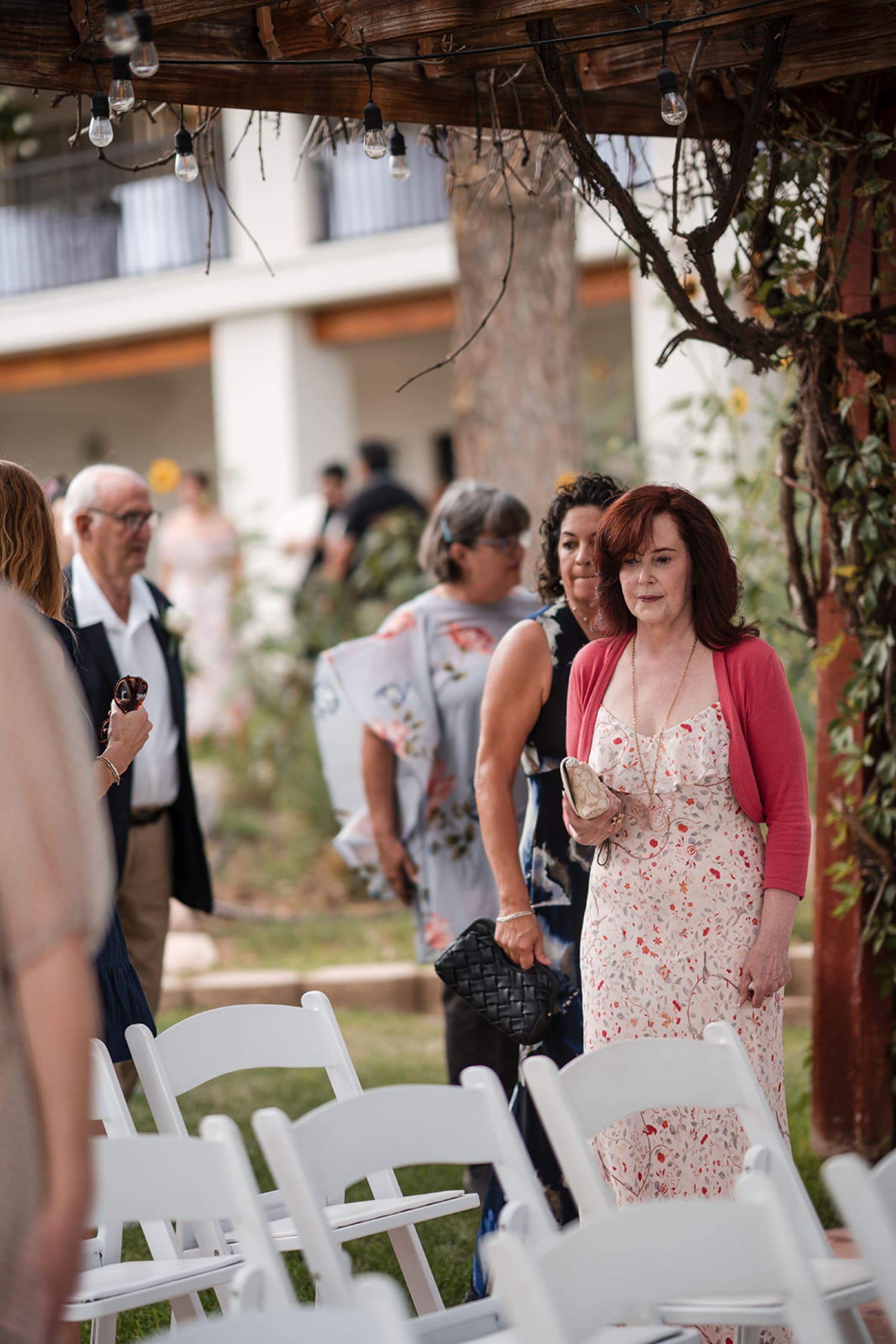 garden ceremony takes place in a rustic courtyard venue featuring weathered wooden beams overhead... — Casey Addason Photography