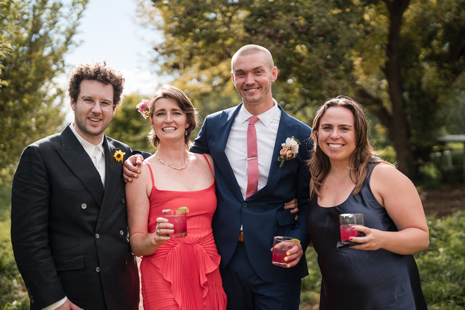 garden portrait captures four well-dressed guests at what appears to be a late-afternoon celebrat... — Casey Addason Photography