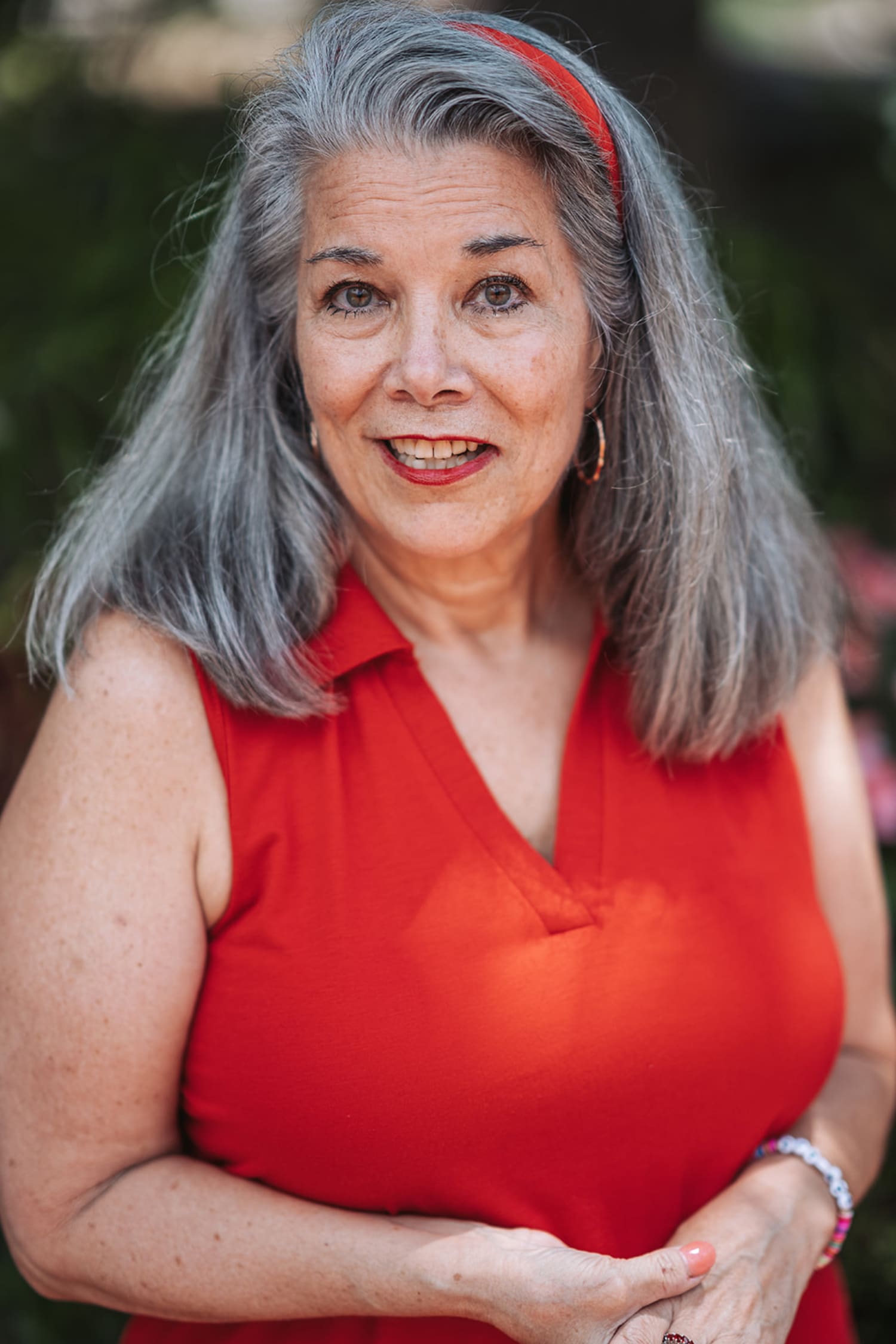 is an outdoor portrait photograph taken in natural daylight, featuring a woman against a softly b... — Casey Addason Photography