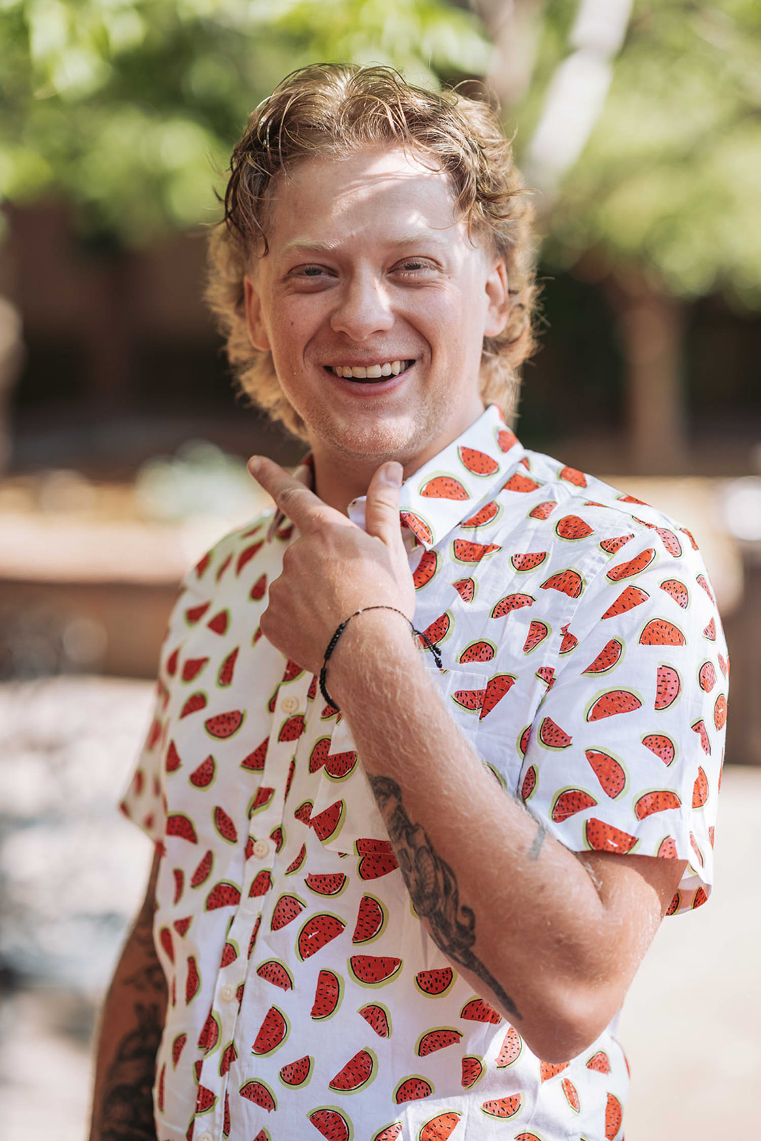 casual outdoor portrait taken in natural daylight, featuring a man wearing a white short-sleeved ... — Casey Addason Photography
