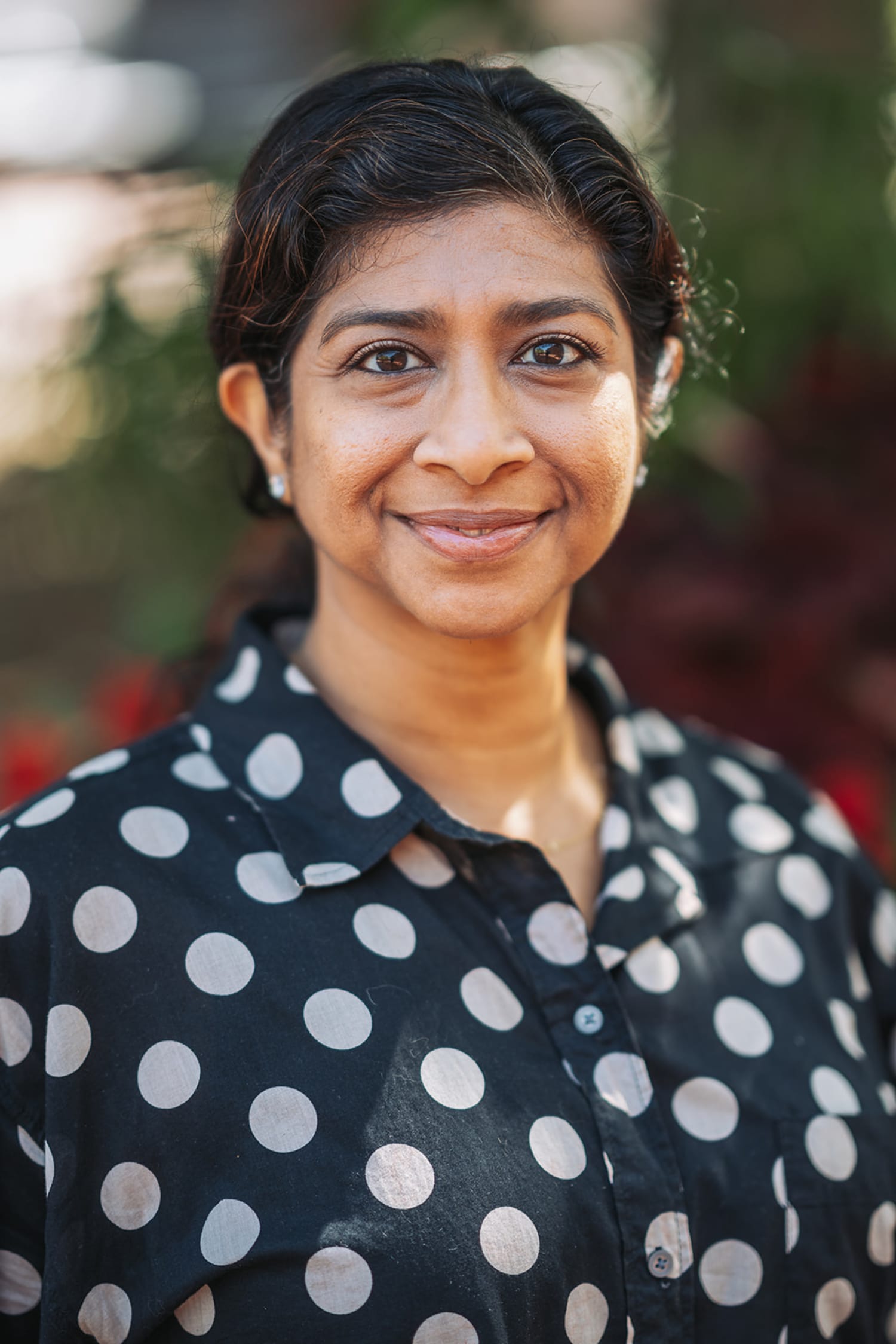 professional headshot taken outdoors in natural daylight, featuring a woman smiling warmly at the... — Casey Addason Photography