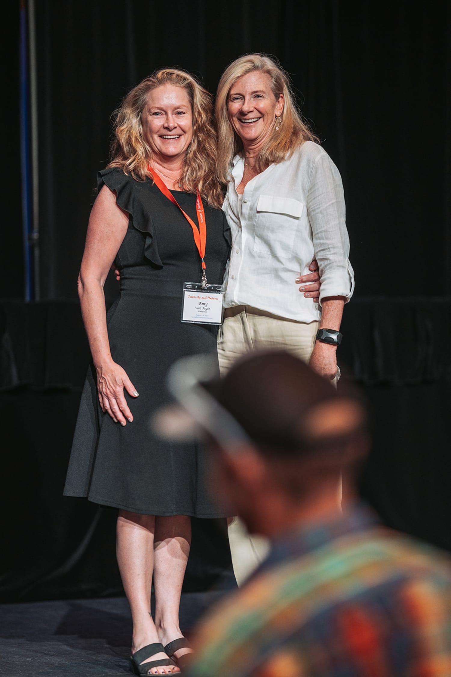 appears to be a professional conference or gala event held indoors on a stage with a dark backdro... — Casey Addason Photography