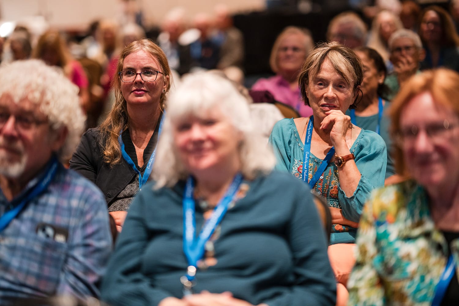 event photograph captures attendees wearing blue lanyards, suggesting a conference or professiona... — Casey Addason Photography