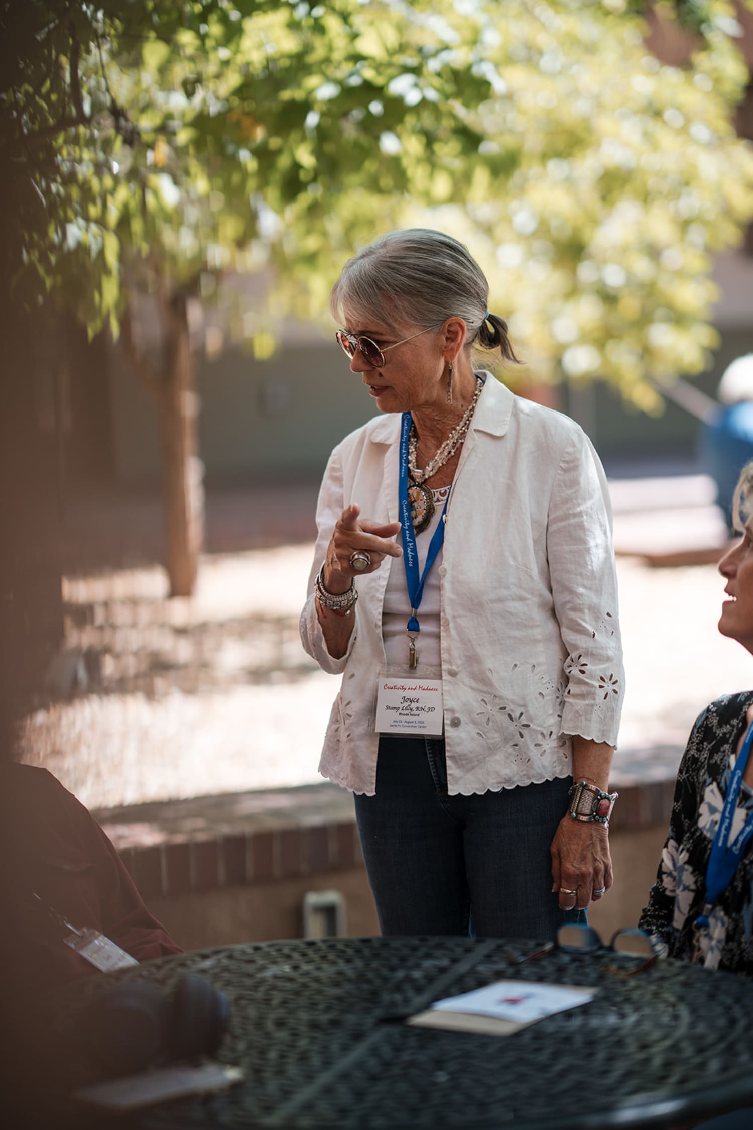 event takes place in a sun-drenched courtyard featuring Southwestern adobe architecture and matur... — Casey Addason Photography
