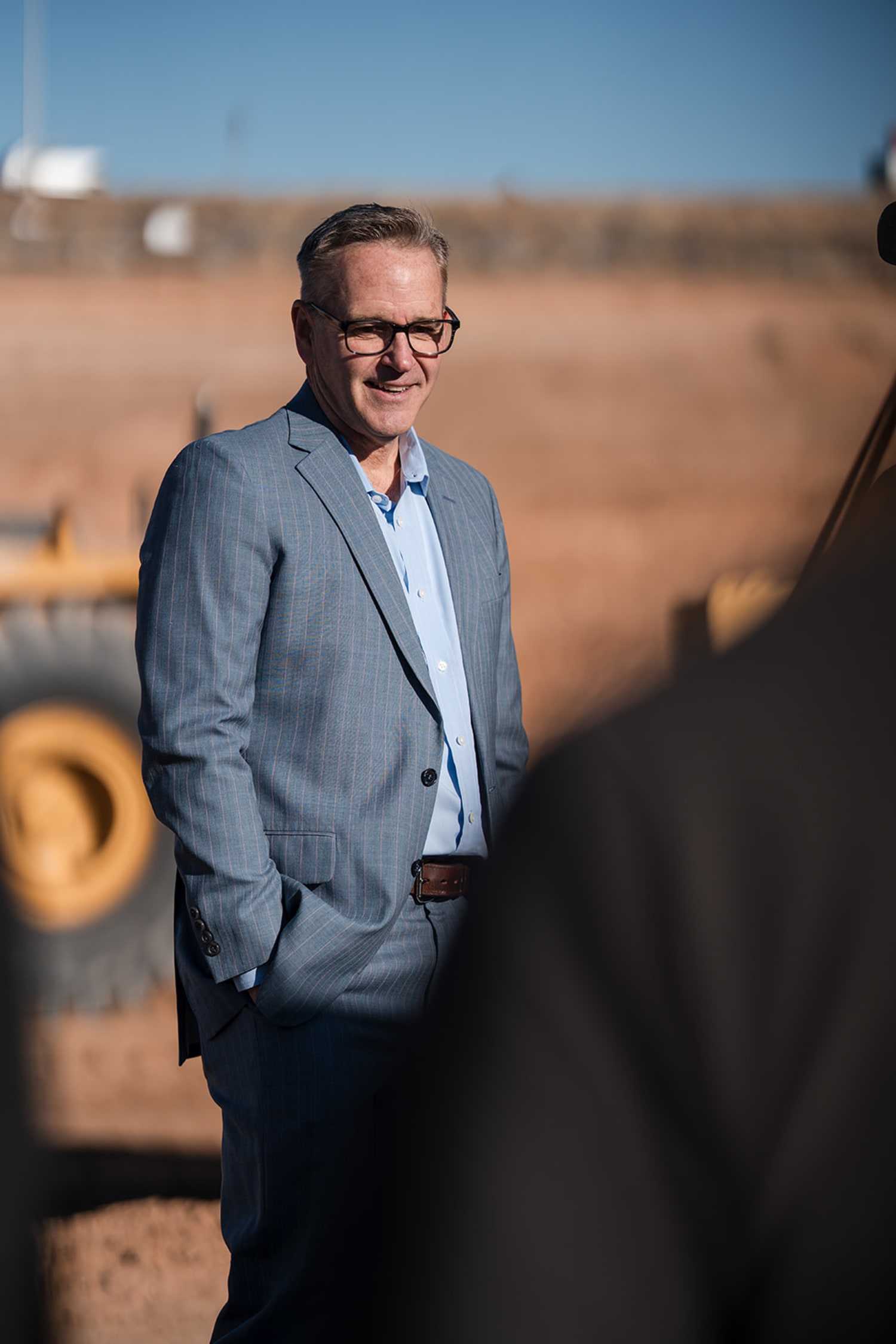 Professional portrait of executive in blazer against arid New Mexico landscape at corporate event - Casey Addason Photography