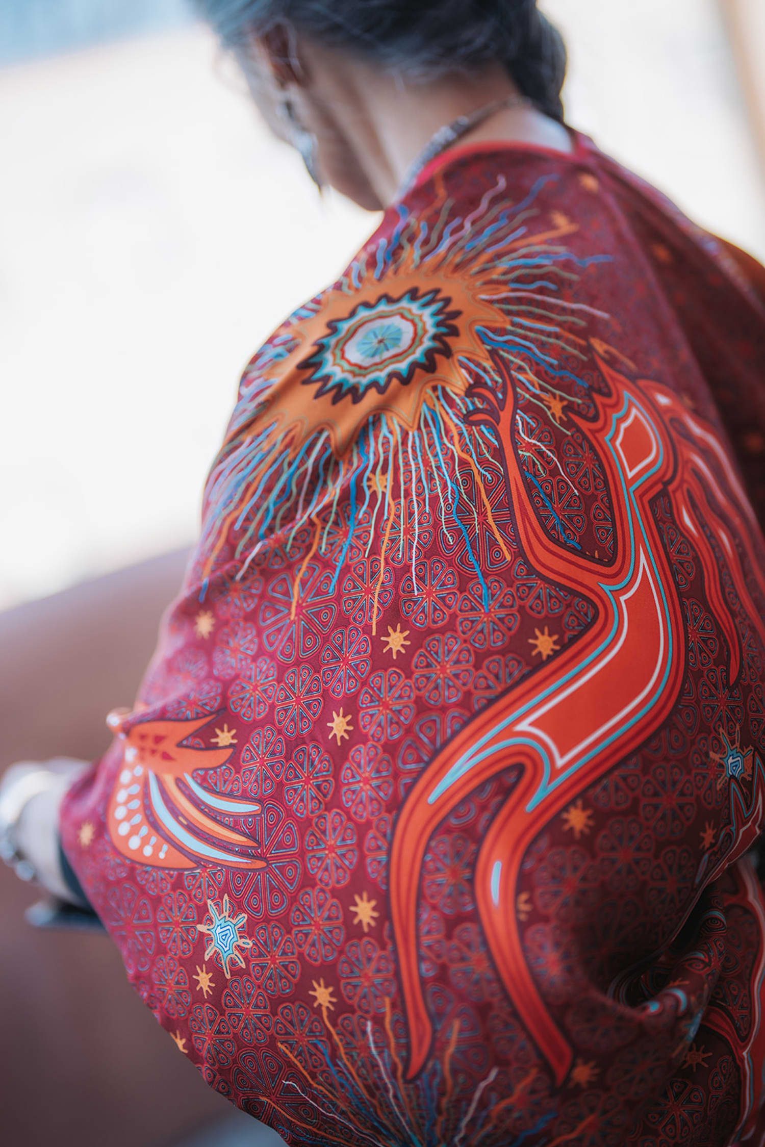 Traditional red ceremonial rebozo with embroidery and celestial motifs, golden hour light, Southwestern cultural traditions at Inn of the Five Graces, Casey Addason Photography
