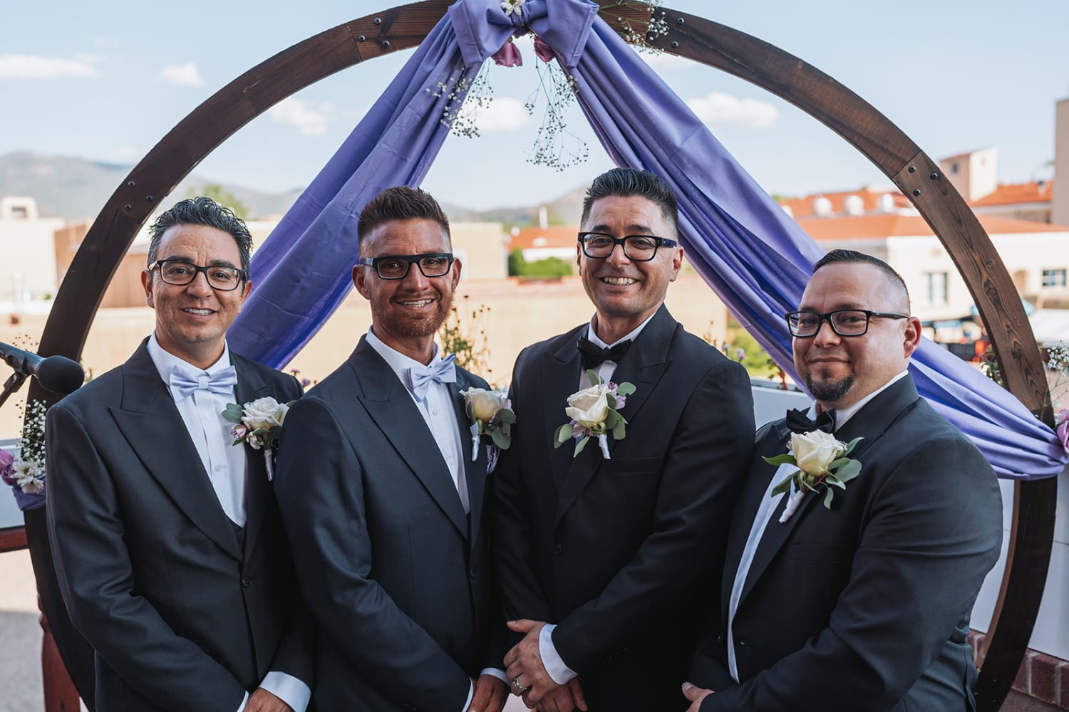 Wedding ceremony under a wooden arch with New Mexico mountain backdrop — Casey Addason Photography