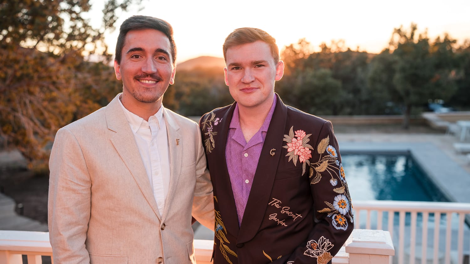 portrait captures two men posed at dusk on what appears to be a residential terrace overlooking a... — Casey Addason Photography