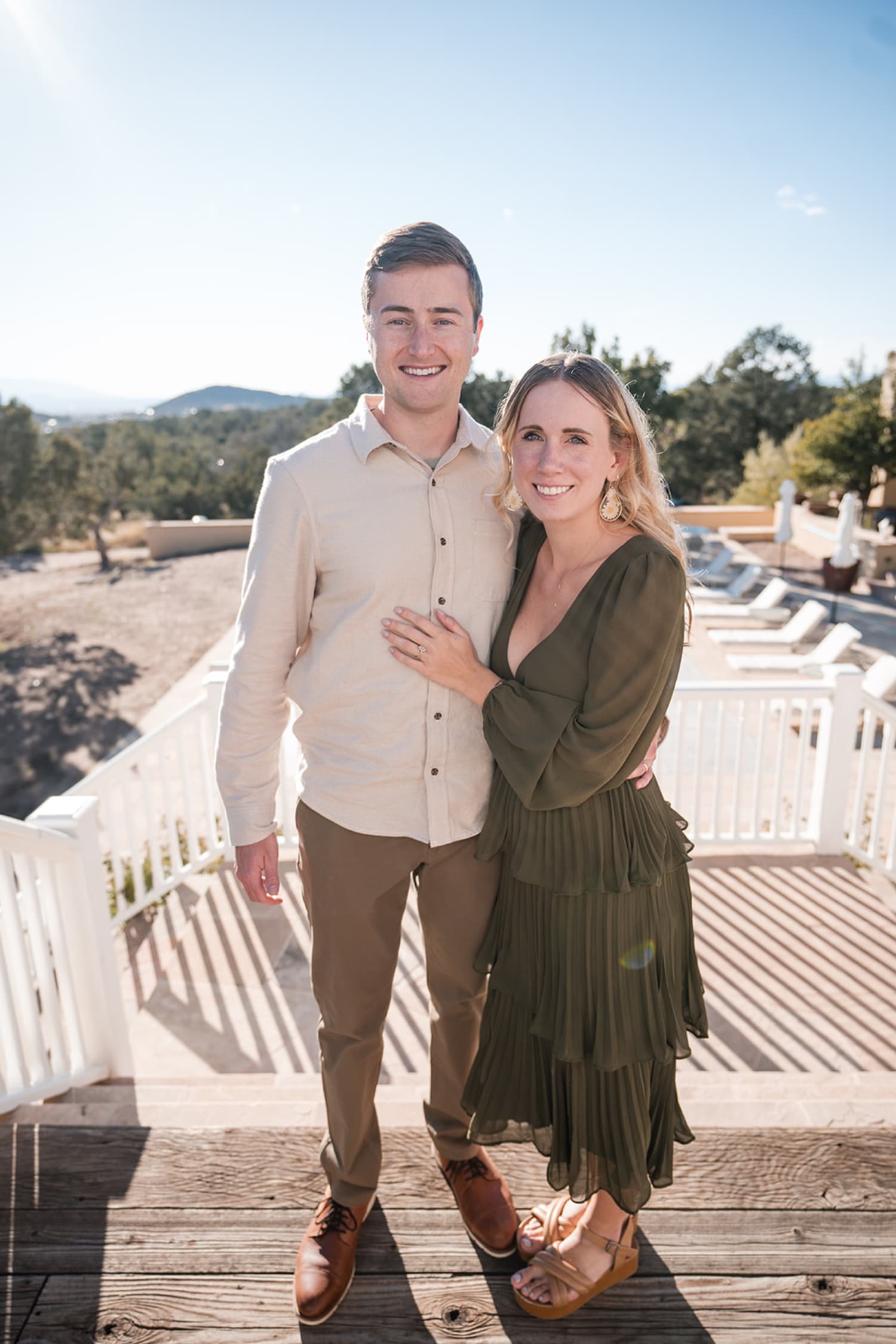 engagement portrait captures a couple on an expansive wooden deck of a modern residential propert... — Casey Addason Photography