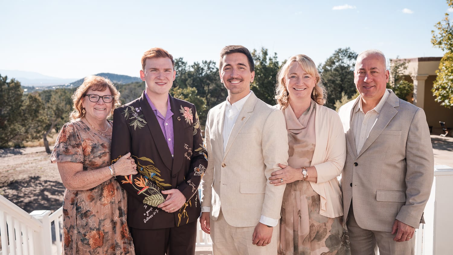 portrait captures five family members posed on a terrace overlooking a forested mountain landscap... — Casey Addason Photography